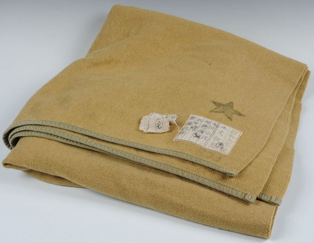 WWII JAPANESE ARMY BLANKET: Full size olive green woolen blanket marked with large black star of Japanese army. Features a printed nomenclature label and small hand lettered name label. Appears to be clean, with no damage or abu