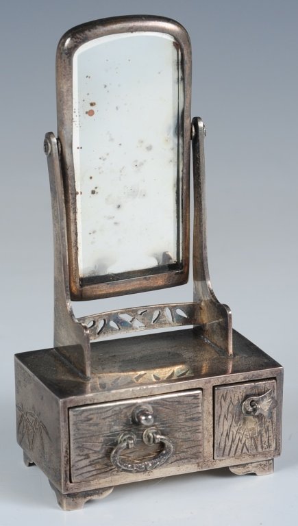 A MINIATURE STERLING SILVER DRESSER WITH MIRROR: Miniature mirrored dresser in sterling silver with drawers holding a salt cellar with a glass insert and a pepper shaker, marked on the base and inside the salt cellar, measures 3.75 x 1.75 x 1 inches