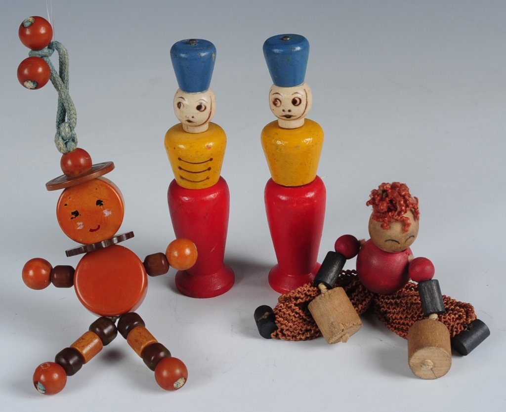GROUP OF BAKELITE AND OTHER VINTAGE CRIB TOYS: Bakelite beads on a blue cord, painted face, measures 5.5 inches, wear to the painting on the face. Plus a beaded wooden doll and two wooden soldiers, measure 4 inches each, signs of age and use.