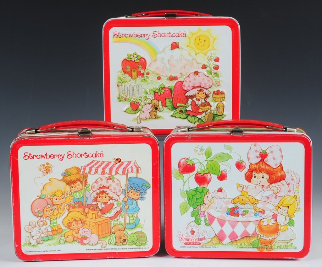 THREE STRAWBERRY SHORTCAKE LUNCH BOXES: 1980, 1981 and 1985; all three including matching plastic thermoses.