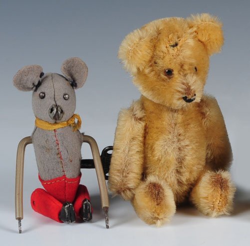 SCHUCO TUMBLING MOUSE AND A VINTAGE YES-NO BEAR: Schuco wind-up tumbling mouse, measures 4 inches, nose is worn through, felt paws are missing from the arms, felt worn away on the back, winds and runs freely, key is present. Plus a mohair jointed te