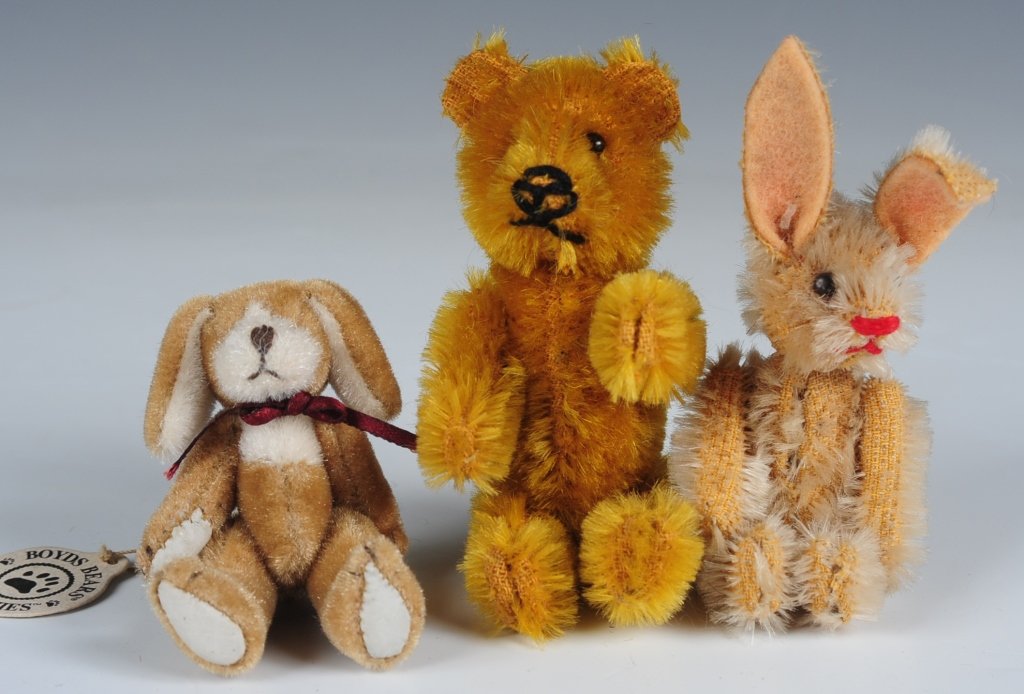 TWO MINIATURE JOINTED RABBITS AND A BEAR: Vintage and modern mohair miniature stuffed animals, most unmarked with the exception of a Boyd Bears rabbit with a pin back, measure from 2.25 to 3.5 inches.