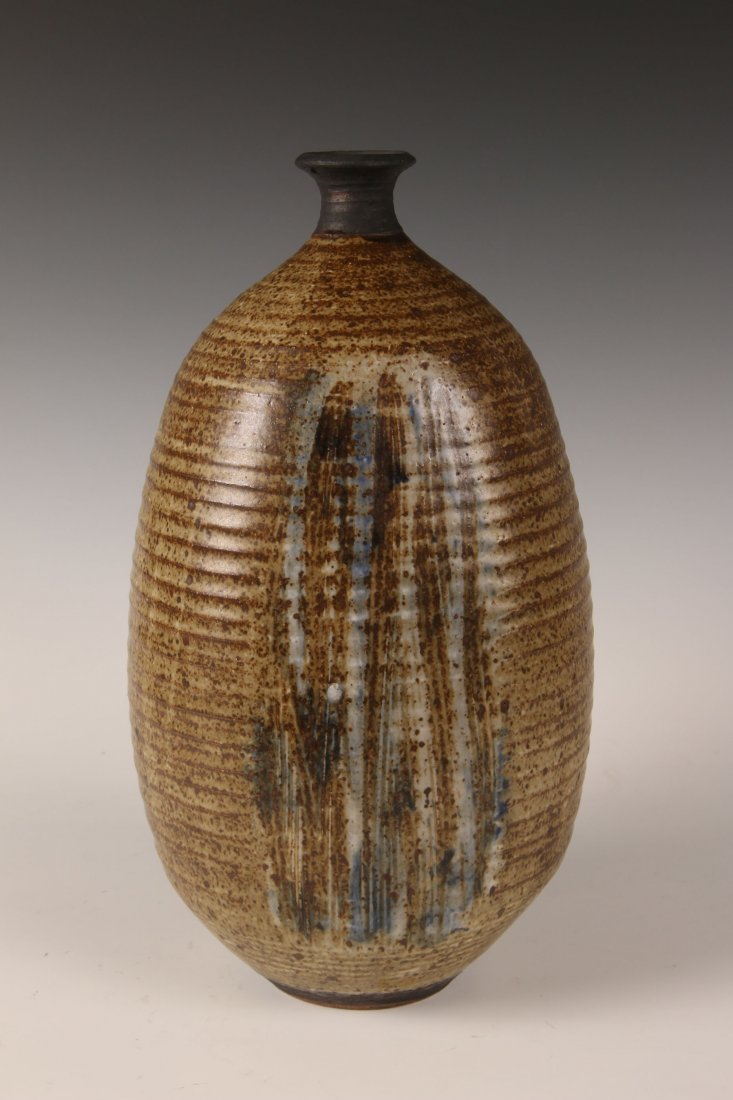 VIVIKA AND OTTO HEINO STONEWARE BOTTLE VASE: A wheel thrown stoneware bottle vase with flattened sides. Scratched signature under the base. Measures 15 inches high. Very fine condition. ​We are happy to offer in-house shipping for all but 