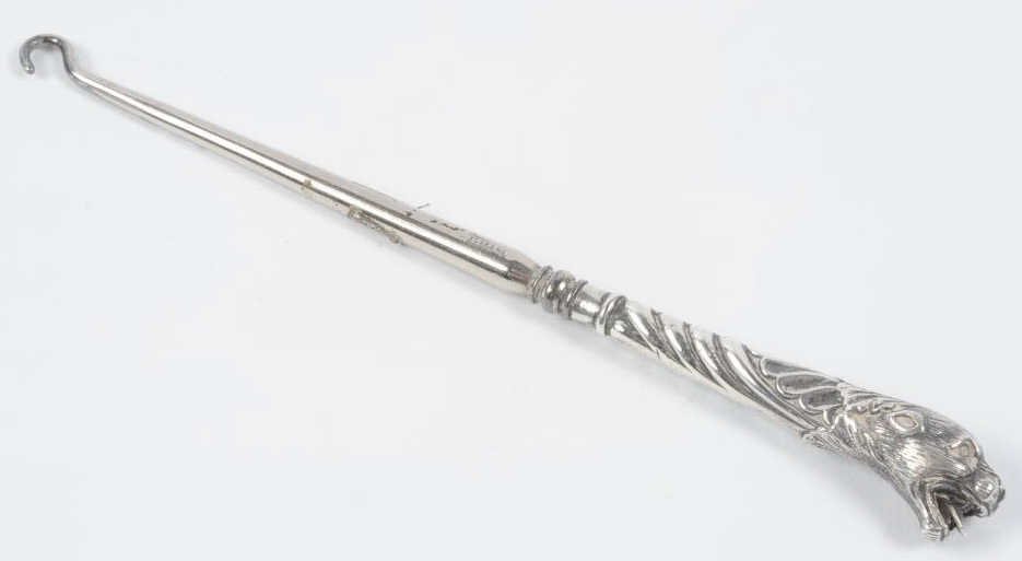 ANTIQUE FIGURAL LION'S HEAD BUTTON HOOK: Marked 'Steel' on the hook, measures 6.75 inches. This lot is not from the Mundwyler-Moulthrop estate. We are happy to offer in-house shipping for all but very large or very fragile items. Some intern