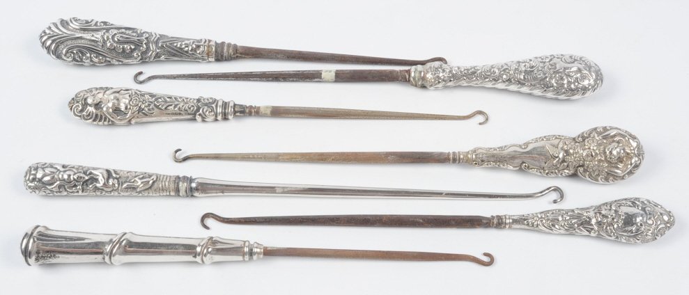 SEVEN OVERSIZED STERLING HANDLE BUTTON HOOKS: Antique button hooks with weighted sterling handles, all marked for sterling, measure from 10.5 to 12.75 inches. This lot is not from the Mundwyler-Moulthrop estate. We are happy to offer in-house shi