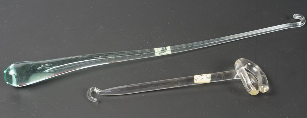 BLOWN GLASS BUTTON HOOKS: One with an encased bubble, unsigned, measure 5.5 and 10 inches. This lot is not from the Mundwyler-Moulthrop estate. We are happy to offer in-house shipping for all but very large or very fragile ite