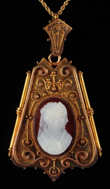 ETRUSCAN WORK LOCKET WITH CARNELIAN HARDSTONE CAMEO: An unmarked gold-filled locket with carved carnelian cameo. Included is a photograph of the locket being worn by Emma Mundwyler of San Francisco California. Measures 2.5 x 1.5, on a 20-inch chain neck