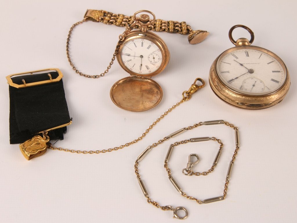 ANTIQUE POCKET WATCHES AND CHAINS: Gold-filled items that include: a Waltham 7 jewel pocket watch in a hunter's case, with a 9 inch chain and fob, measures 2 inches; an Elgin 7 jewel key wind pocket watch, no key present, measures 3 in