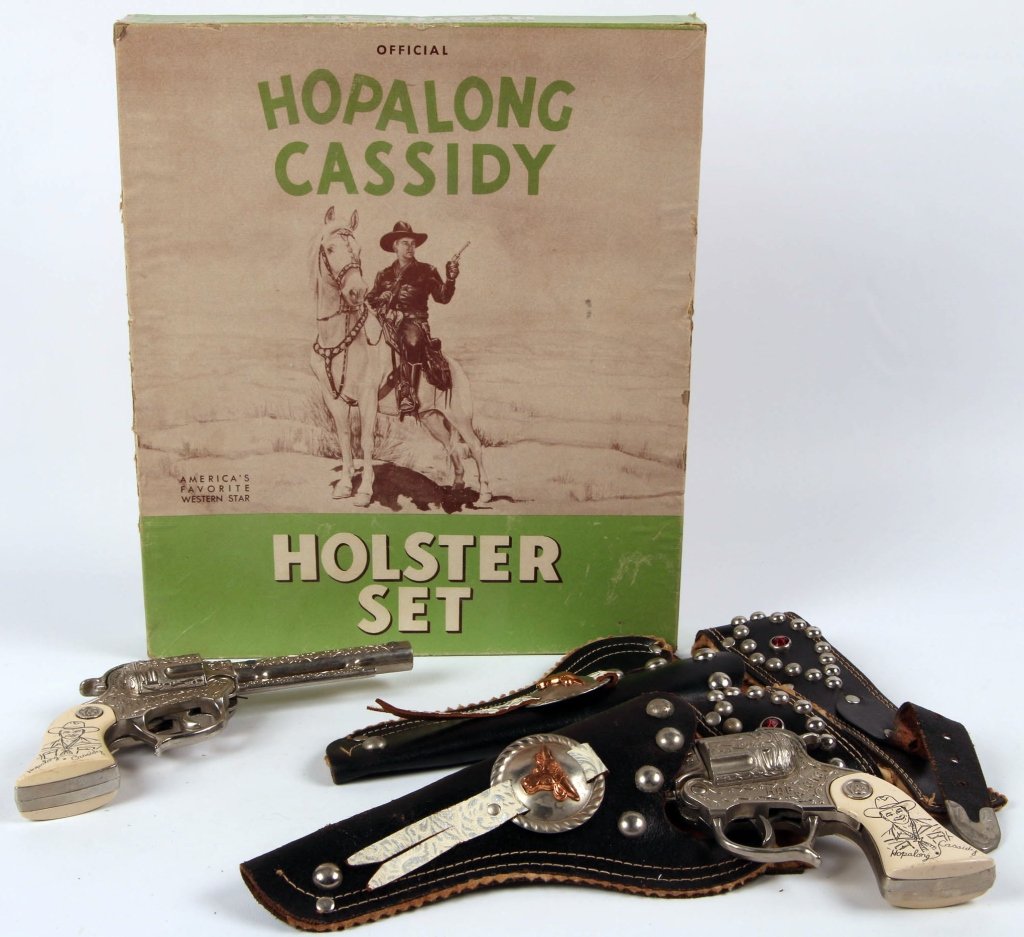 HOPALONG CASSIDY TOY HOLSTER AND PISTOL SET IN BOX: Leather holsters and belt with two cap pistols in original box. We are happy to offer in-house shipping for all but very large or very fragile items. Some international orders may need to be handled b