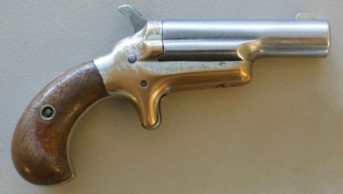 COLT DERRINGER SINGLE BARREL .41 CALIBER (?): Rim fire, brass frame, round butt, walnut plates, 5 inches overall, no numbers, marked 'Colt' on barrel. Provenance: Carlton Chester Moulthrop. See lot 168 for more items from C.C. Moulthrop. We are h
