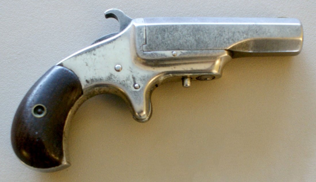 XL DERRINGER SINGLE BARREL .44 OR .45 CALIBER: Rim fire, no I.D. numbers, 5 inches overall. Provenance: Carlton Chester Moulthrop. See lot 168 for more items from C.C. Moulthrop. We are happy to offer in-house shipping for all but very large or ve