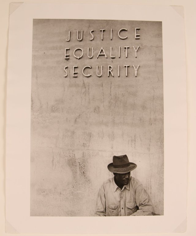 MICKEY PALLAS PHOTOGRAPH SUGAR WORKER 1955: A sugar worker on reserve during a long strike in Louisiana 1955 during which the demands, among other things, asked for the abolition of segregated pay lines for black workers and white workers. Sign