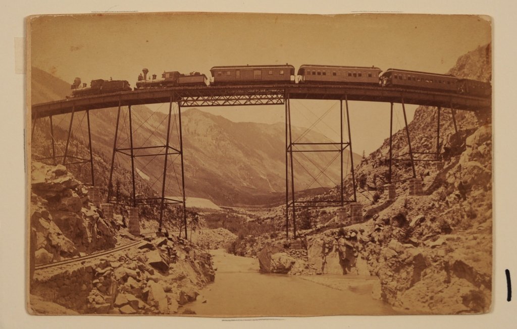 LOT OF 19TH AND EARLY 20TH CENTURY PHOTOGRAPHY: 1. Mounted albumen photograph train over canyon by photographer A. Martin and published by Robert M. Davis. Clear Creek Canyon, Georgetown and vicinity, Colorado. Union Pacific Railroad, measures 4.25