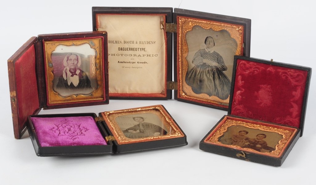 CASED 19TH CENTURY PHOTOGRAPHIC IMAGES: Including a 1/6th plate daguerreotype portrait of a woman in a complete leatherette case. Plus and ambrotype of two children hand tinted separated case, a 1/4th plate ambrotype of lady in satin dress 