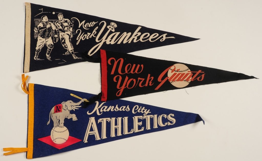 LOT OF VINTAGE FELT BASEBALL TEAM PENNANTS: New York Giants, Kansas City Athletics and the New York Yankees, measure from 8.5 x 25 inches to 11 x 28 inches. Provenance: The Estate of Kansas Artist David Melby. We are happy to offer in-house shi
