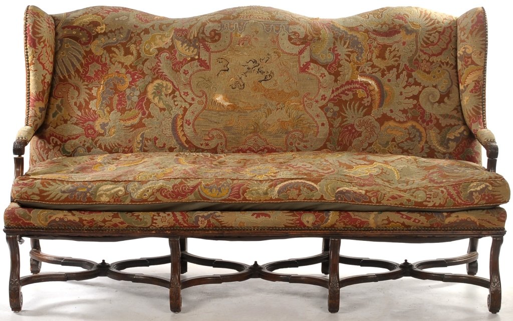 AN 18TH C. Louis XIII-Style Needlepoint Wingback SOFA: Triple arched crest rail above a needlepointed upholstered back flanked by shaped wings continuing to padded arms with exposed handholds, centering a long needlepoint feather filled cushion, and raise
