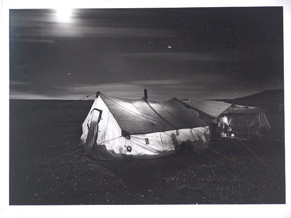 BARBARA VAN CLEVE (20/21ST C) SILVER GELATIN PRINT: An original silver gelatin print #15 from an edition of 125, titled 'Moon (and Star Tracks) Over Cook Tent' lower left, pencil signed lower right with a date of 1985. Actual print size of 16.25 x 22.7