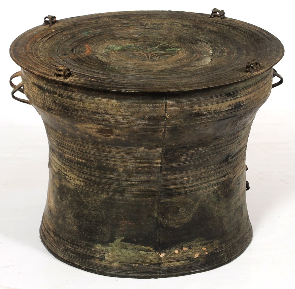 AN ANTIQUE THAI BRONZE RAIN DRUM WITH FIGURES: Thai Bronze Rain Drum, with four cast animals on top, characteristic multi-point star in center of top surrounded by bands of incised designs that continue down the sides, row of figural elephant cast