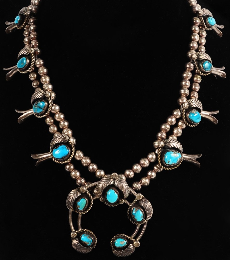 A NAVAJO SILVER AND TURQUOISE SQUASH BLOSSOM NECKLACE