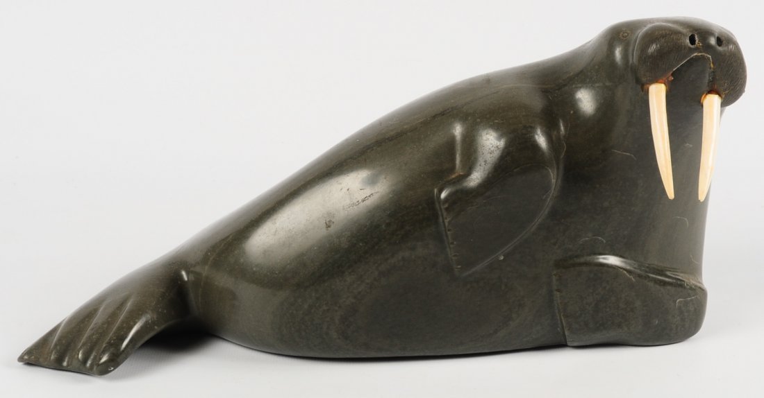 A SLEEK, STYLIZED INUIT SOAPSTONE FIGURE OF A WALRUS (1 of 10)