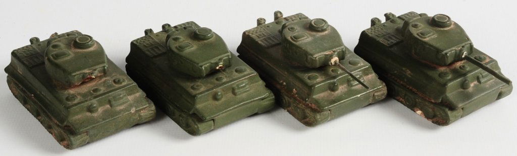 FOUR GOEBEL TIGER TANK SAND TABLE MODELS: Four ceramic tanks with rotating turrets, marked Tiger, all with crown marked turret bases. Two missing gun barrels. Approximately 2-1/2 x 1-5/8 inches. We are happy to offer in-house shipping for all