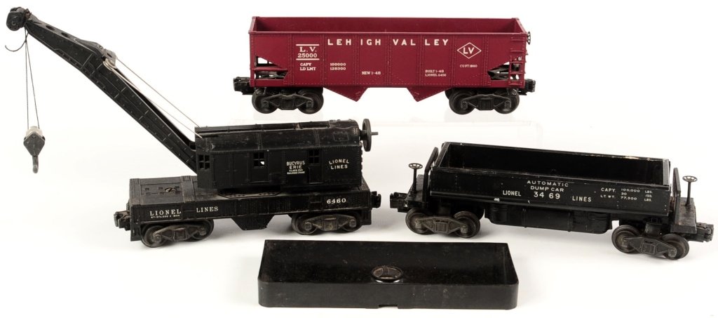 THREE LIONEL POSTWAR FREIGHT CARS: Including #6460 crane car, #6456 LV hopper, #3469 dump car with #160 bin. We are happy to offer in-house shipping for all but very large or very fragile items. Some international orders my need to be 