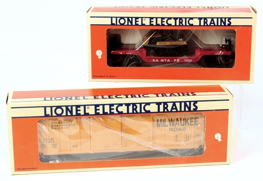 TWO LIONEL LLC FLATCAR AND BOXCAR: Including #16955 ATSF flatcar with ERTL Challenger and #17223 Milwaukee Road double-door boxcar. Both in boxes. We are happy to offer in-house shipping for all but very large or very fragile items. So