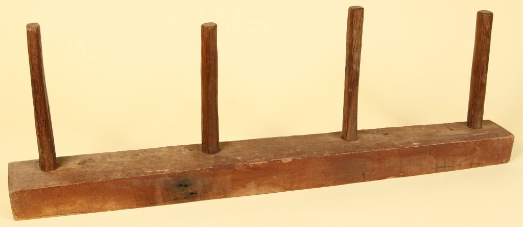 A PRIMITIVE 18TH C. PINE HERB DRYING RACK: Measures 14 x 43 x 4 inches.