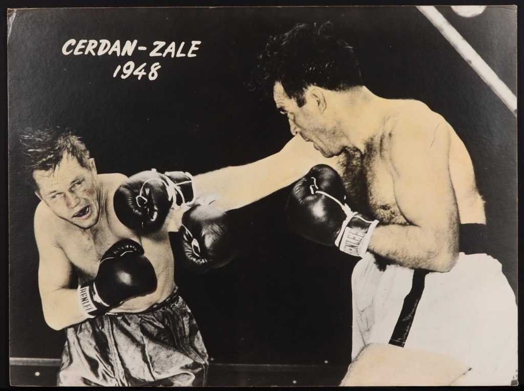 HAND COLORED PHOTO OF BOXERS CERDAN - ZALE: Print from a 1948 photo, Marcel Cerdan vs. Tony Zale, mounted on chip board, measures 40 x 30 inches.