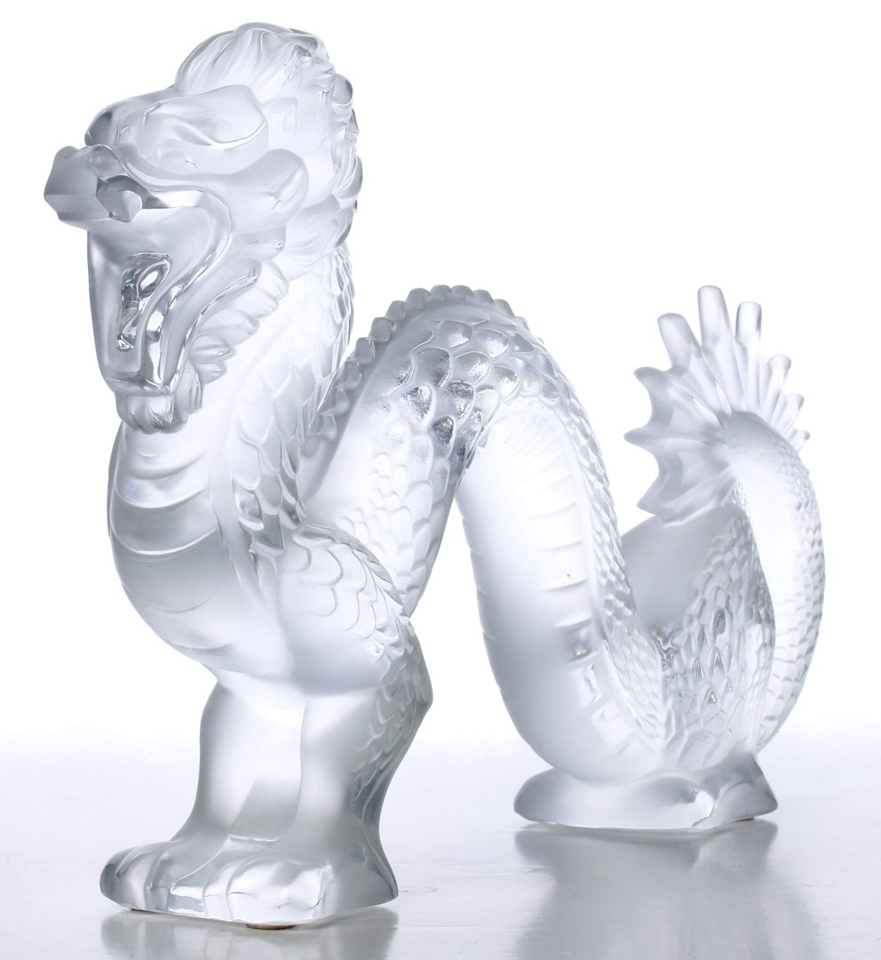 A LALIQUE FRENCH CRYSTAL SCULPTURE OF A DRAGON: Engraved signature along the base near the back feet, measures 7.5 x 10 x 2 inches. We are happy to offer professional in-house shipping. Cost of labor and materials start at $12 per box used.