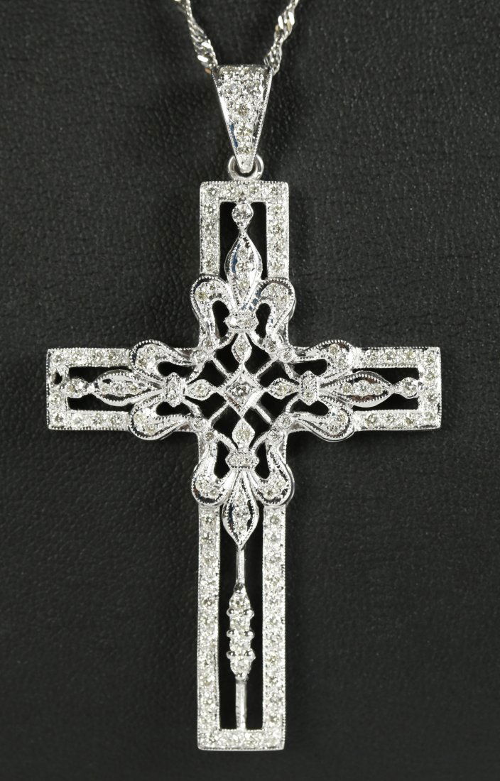 A PLATINUM AND DIAMOND SET CROSS PENDANT (1 of 10)