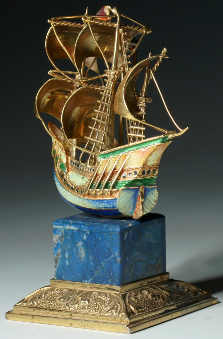 AN 18K GOLD ENAMEL MASTED SHIP PIN ON LAPIS STAND: A very fine Italian 18k gold galleon or masted ship pin enameled in green, yellow and blue. Marked 18k Italy inside the hollow back. The ship pin mounts by a threaded post to the lapis and silver gilt