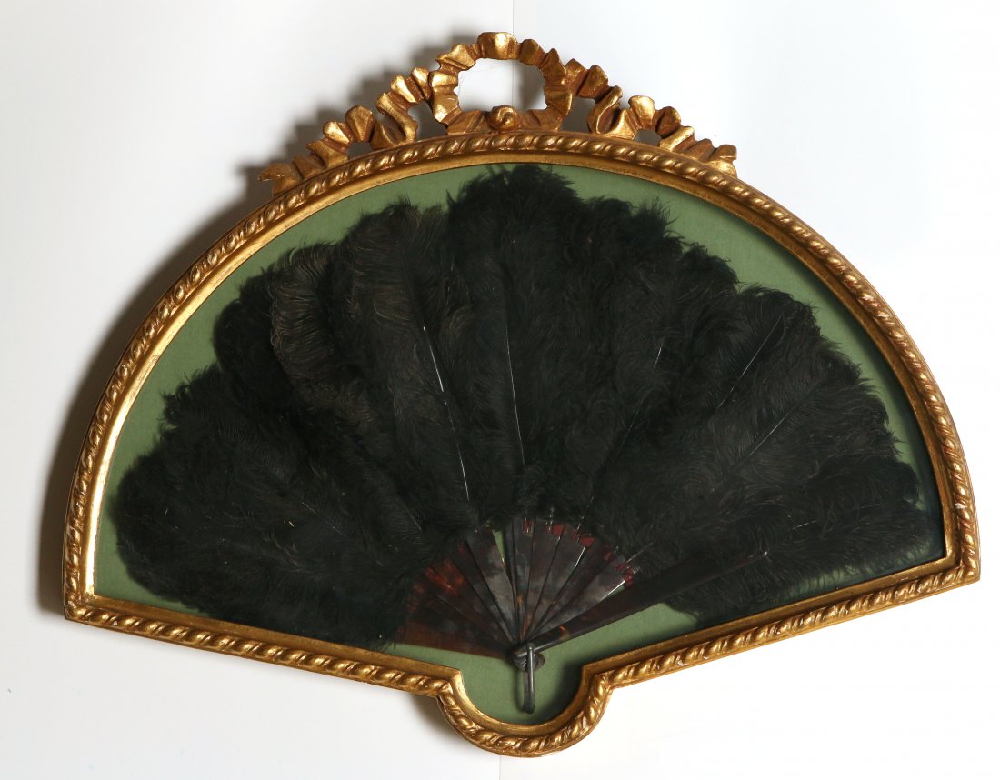 A FRAMED VICTORIAN OSTRICH FEATHER HAND FAN: In shadow box case that measures 19 x 24 inches.