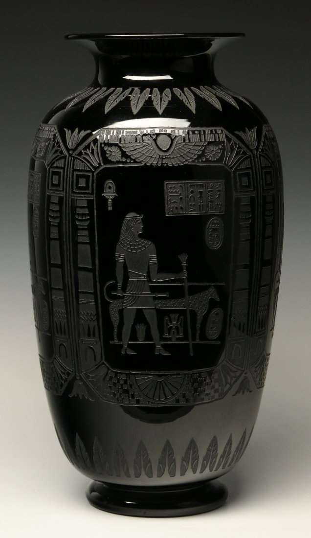A 16.5 INCH ACID CUT BACK VASE ATTRIBUTED SINCLAIRE: An Art Deco period Egyptian Revival motif intaglio decorated glass vase attributed to the H.P. Sinclaire Glass Company's Nubian Black line. This large and impressive mirror black glass vase has a flar