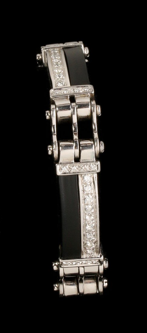 A 14K 'BIKE CHAIN' BRACELET APPROX. 2.75 CARATS TW: A men's bracelet set with sixty-eight .03 to .05 carat diamonds and four bars of black rubber in the 14k gold 'belt buckle' or 'bicycle chain' type links, measures 8-3/4 to 9-1/8 inch per the adjustab