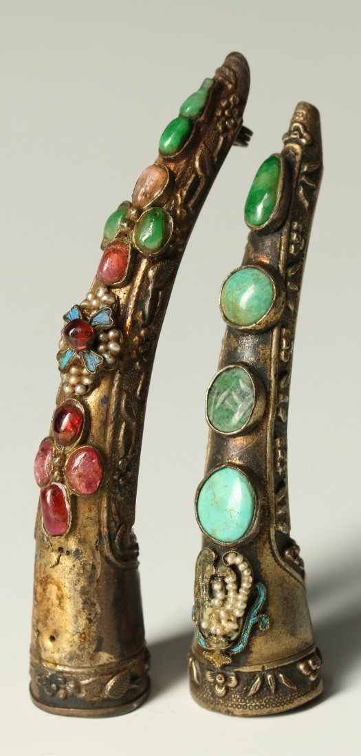 TWO 19TH CENTURY CHINESE SILVER NAIL GUARDS: Two silver nail guards with turquoise, quartz and other semi-precious stones along with seed pearls and enamel decoration,, traces of gilding. One has had a catch added to be worn as a brooch but the 
