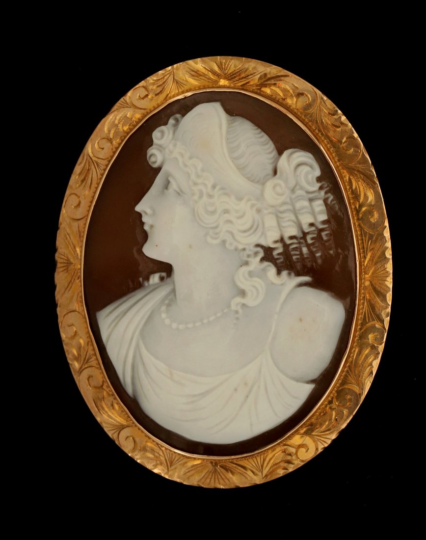 A LARGE ANTIQUE CARVED SHELL CAMEO BROOCH: The hand engraved border displaying a very nicely carved and artist signed cameo that measures 49 x 37mm, the brooch/pendant mounting measures 2.5 x 1.75 inches and weighs 13 grams. This and 29 other 