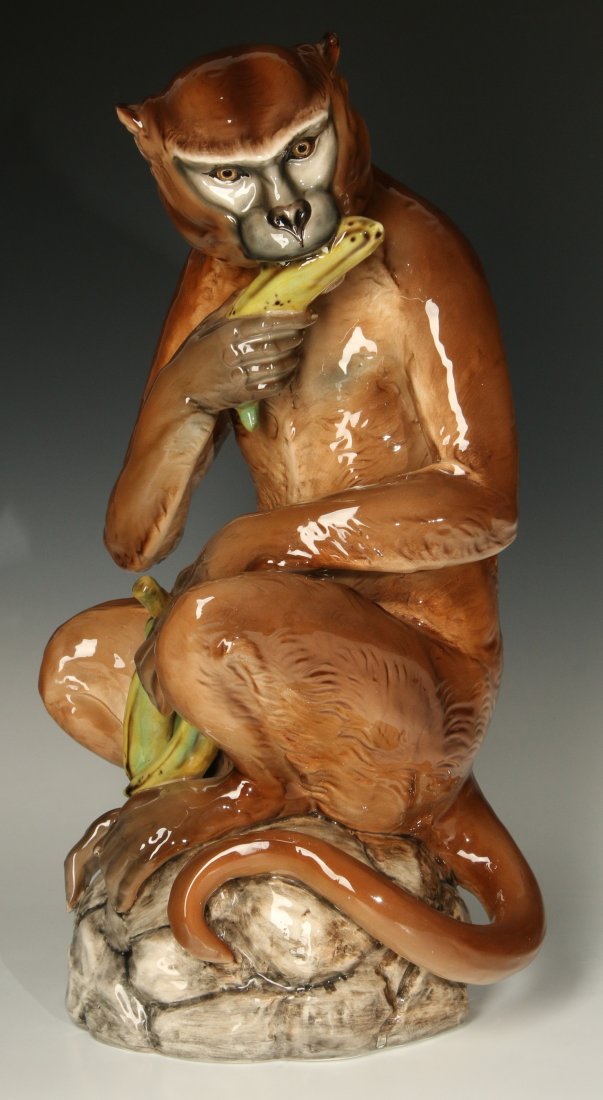 A 20TH CENTURY ITALIAN POTTERY FIGURE: A glazed earthenware figure of a monkey by an unknown Italian maker. Signed on the base in blurred underglaze markings. Measures 18 x 9 inches.
