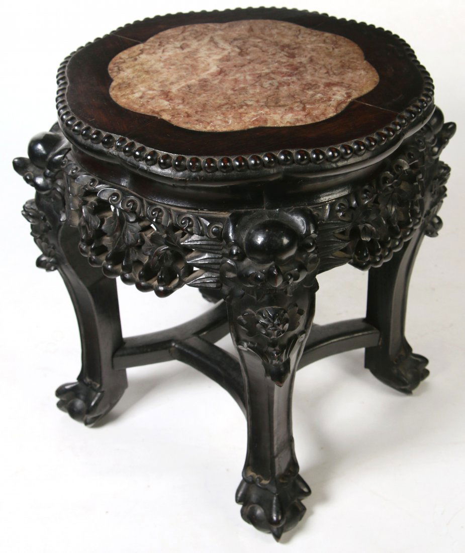 LATE 19TH C. CHINESE CARVED ROSEWOOD SIDE TABLE: A carved rosewood table with shaped marble insert in rosewood frame, heavily carved openwork skirt, four carved legs with bat's faces and paw feet. Measures 16 x 13.75 inches.