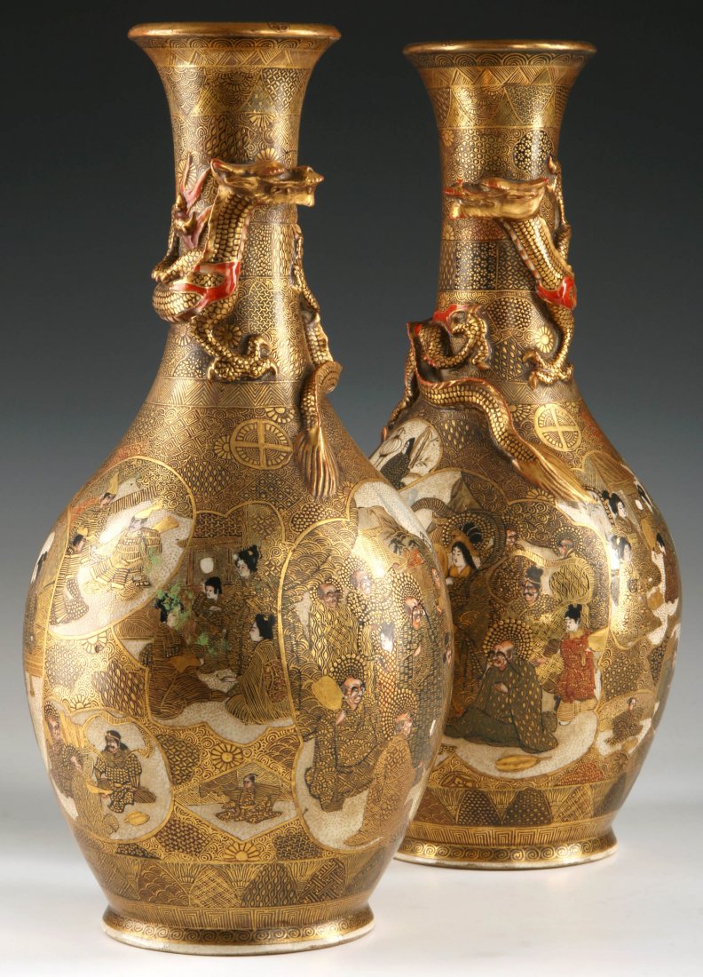 A PAIR MEIJI JAPANESE SHIMAZU CLAN SATSUMA VASES: A pair of Japanese Satsuma ware bottle vases with applied relief design of a dragon curling around the necks, overlapping medallions featuring an assortment of figural and landscape designs including 