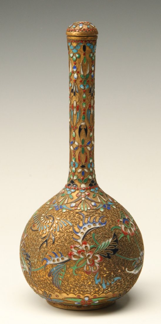 A CHINESE CHAMPLEVE ENAMEL COVERED BOTTLE: Enamels of birds and flowers among applied wire designs in relief on brass. Measures 8.75 x 3.75 inches.