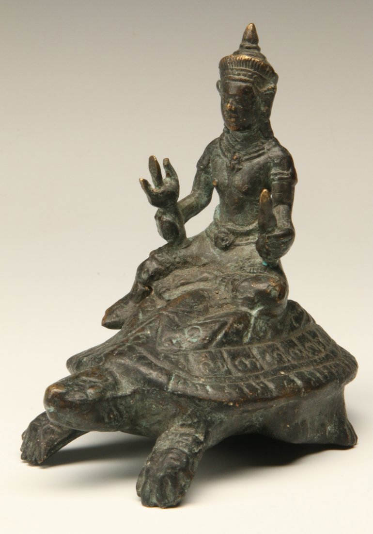 A SOUTHEAST ASIAN BRONZE BODHISATTVA SEATED ON TURTLE: A Thai or Cambodian Bodhisattva seated atop a turtle. Measures 5.25 x 5 inches.