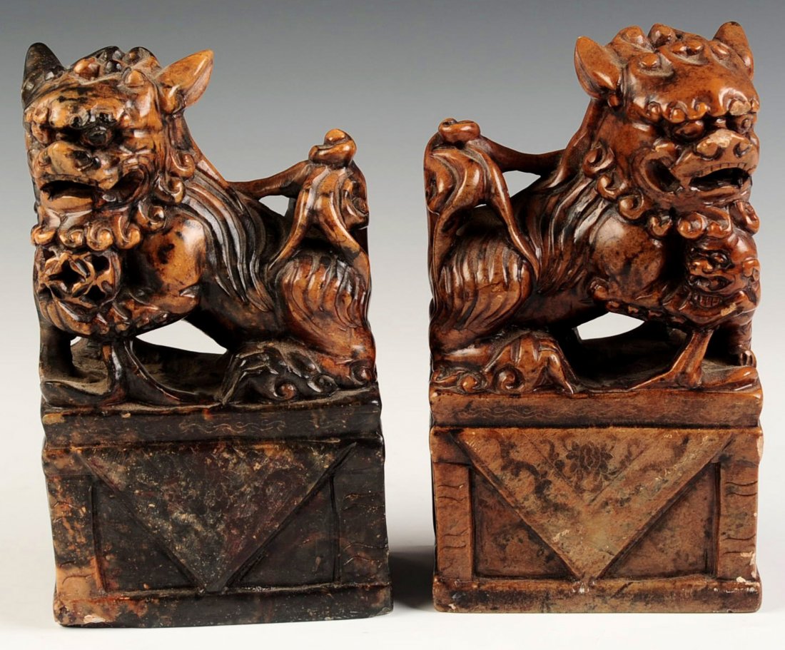 A PAIR CHINESE CARVED SOAPSTONE FU DOGS: Chinese, pair of finely carved soapstone carvings of Fu Dogs, 20th century. Pair measures 6 x 3.5 inches.