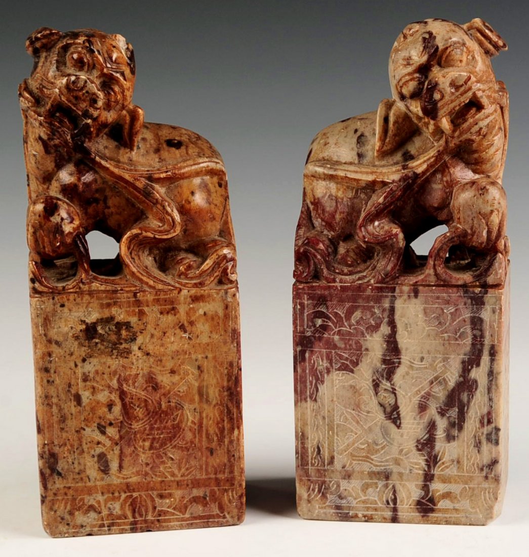 A PAIR CHINESE CARVED SOAPSTONE FU DOGS: A pair of Chinese soapstone carvings of Fu Dogs, 20th century. Pair measures 7 x 2.75 inches.