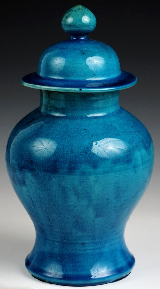 A CHINESE CRACKLE GLAZE MONOCHROME POTTERY GINGER JAR: A covered vase measuring 11.5 x 5.25 inches.