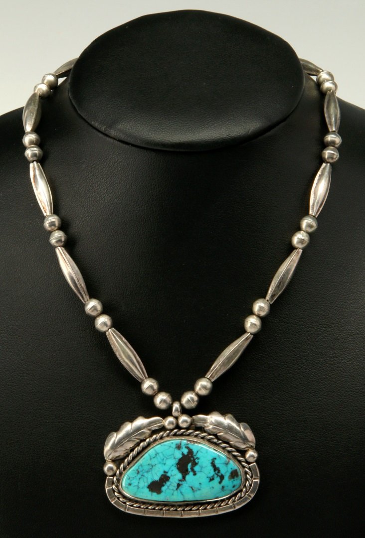 A STERLING SILVER AND TURQUOISE PENDANT (1 of 7)