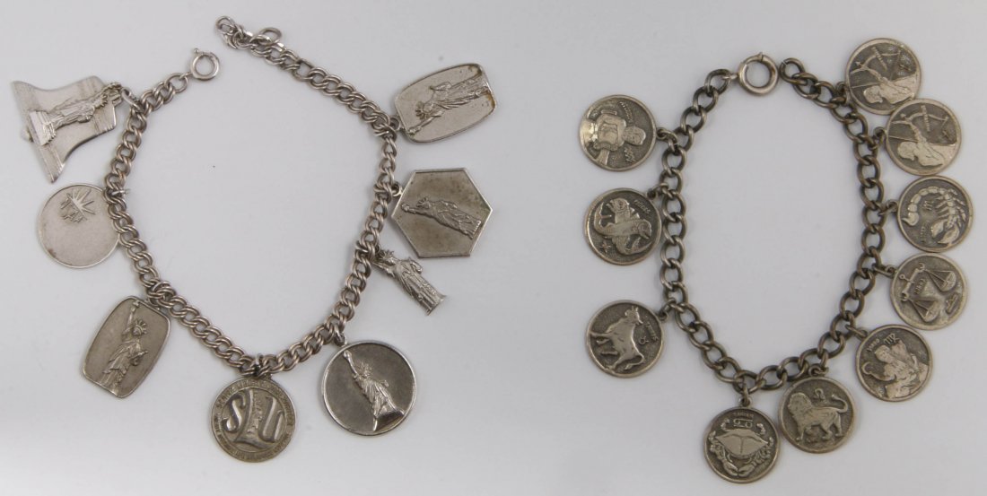 TWO SILVER CHARM BRACELETS WITH CHARMS: The first a 7.25 inch 5mm curb link bracelet has ten zodiac charms and weighs .90 ozt, the second is a 5mm double curb link 8 inch bracelet holds eight charms, some marked sterling and weighs 1.40 ozt