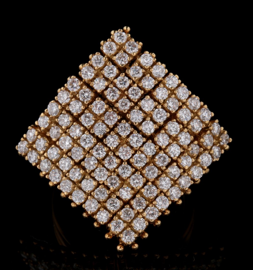 AN 18K GOLD FASHION RING WITH 100 DIAMONDS: The unique construction of a flexible mesh table set with one hundred diamonds estimated at approximately .03 carats in size mounted on a ring mounting stamped 18k gold, total estimated carat weight o