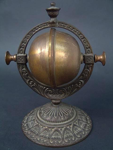 FANCY CAST IRON & BRASS VICTORIAN DINNER BELL: Neat old item that rolls when spun using the outside handles, which rings the bell for servant, tea or dinner. This ornate antique bell has been sitting on top of lot 437, the New Haven mantle clock,