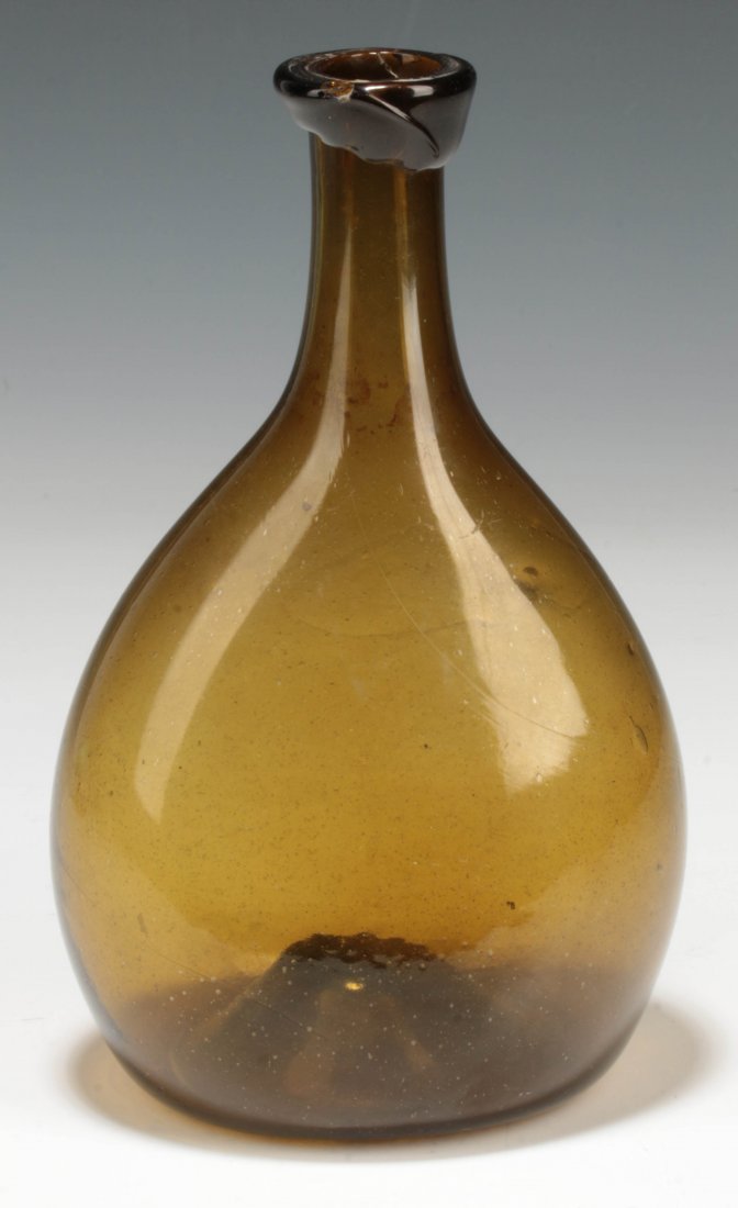A 19TH CENTURY AMERICAN FREE BLOWN CHESTNUT FLASK: A good circa 1800 chestnut form flask with kick-up base and rough pontil, measures approximately 7 x 4.25 inches. We ship in-house for all items with the exception of very large and or very fragile pi